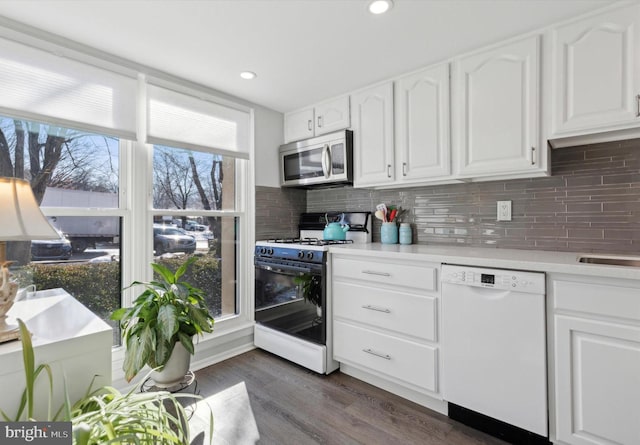 kitchen featuring dishwasher, gas stove, white cabinetry, tasteful backsplash, and dark hardwood / wood-style floors