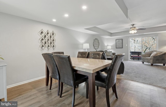 dining space with ceiling fan and wood-type flooring