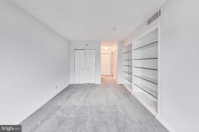 unfurnished bedroom featuring light colored carpet