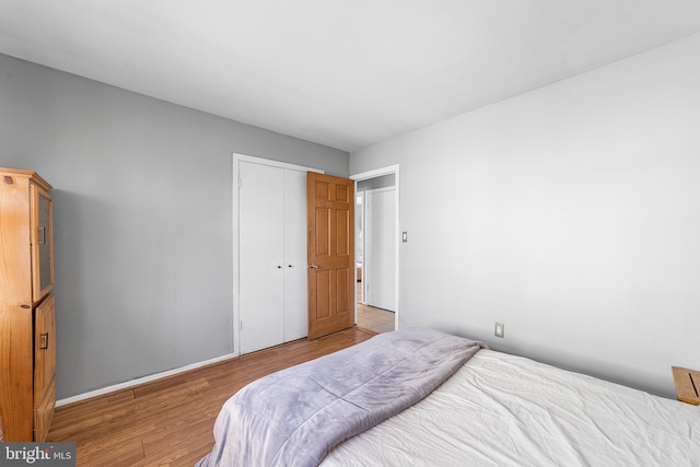 bedroom with a closet and light wood-style floors