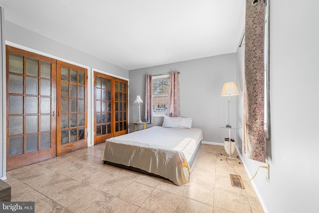 bedroom featuring baseboards, visible vents, and french doors