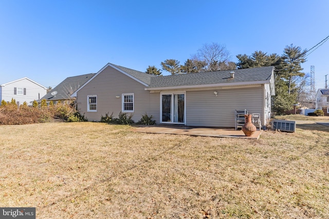 back of house featuring central AC, a patio, and a yard