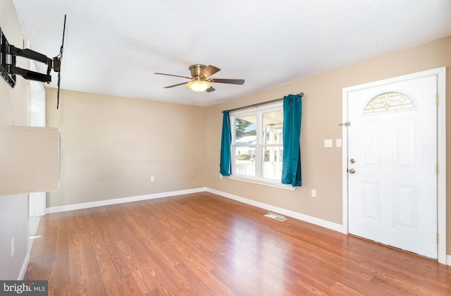 entrance foyer featuring wood finished floors, visible vents, and baseboards