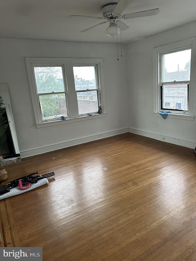 unfurnished room with ceiling fan and wood-type flooring