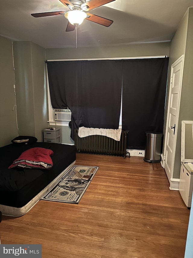 bedroom featuring ceiling fan and wood-type flooring