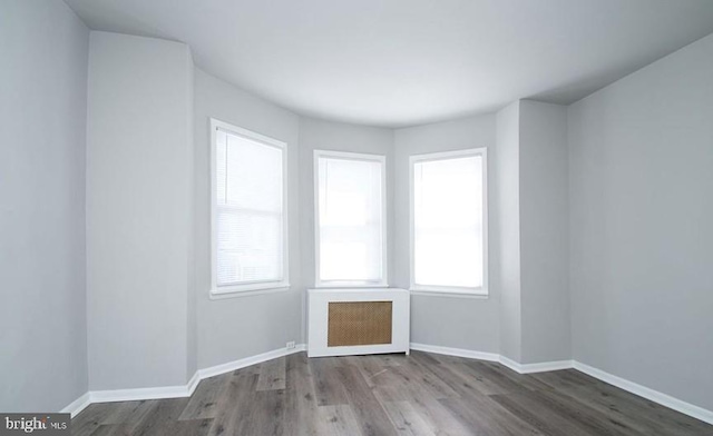 spare room with hardwood / wood-style flooring