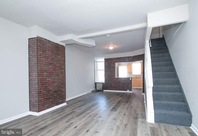 unfurnished living room with hardwood / wood-style floors