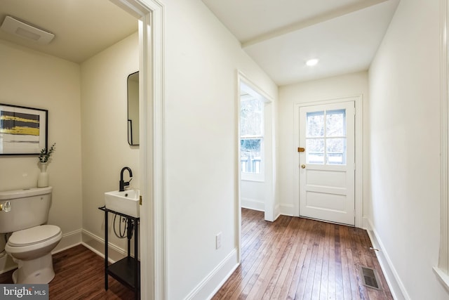 doorway to outside featuring dark wood-type flooring