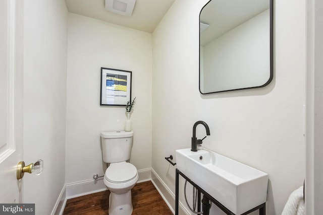 bathroom featuring hardwood / wood-style flooring and toilet