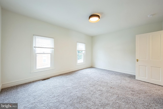 spare room with light colored carpet