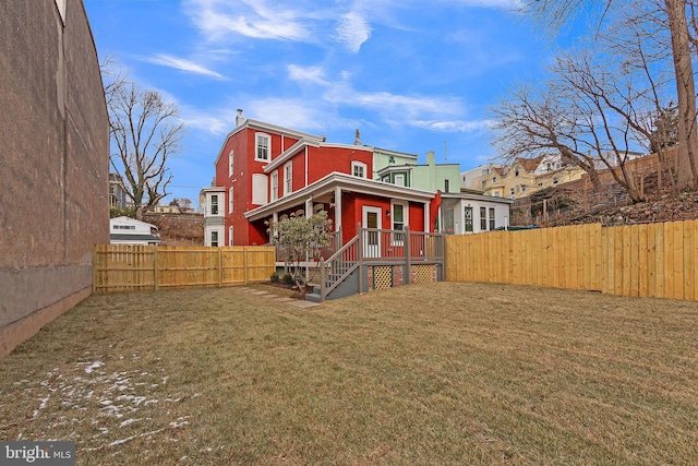 rear view of house featuring a lawn