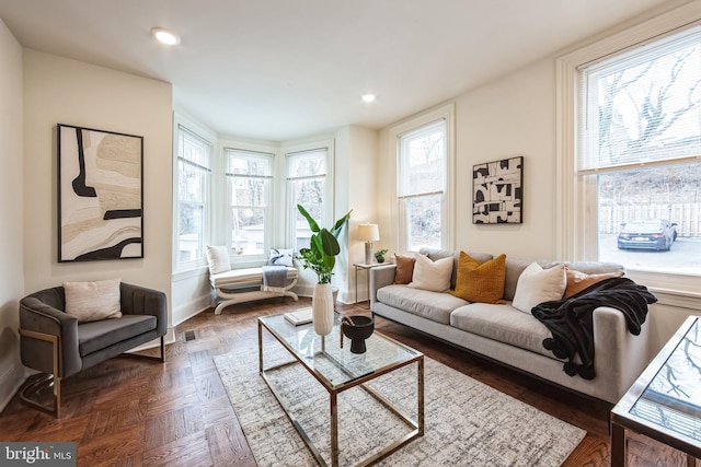 living room featuring dark parquet floors