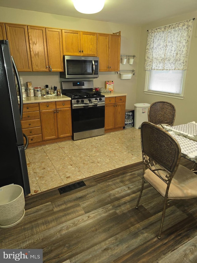 kitchen featuring light hardwood / wood-style flooring and appliances with stainless steel finishes