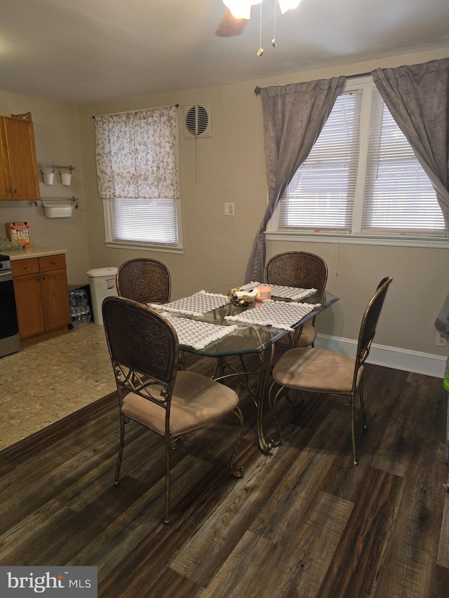 dining area featuring ceiling fan and dark wood-type flooring