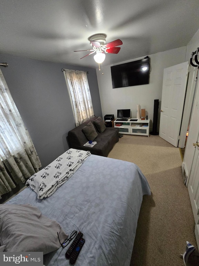 bedroom with ceiling fan and light colored carpet