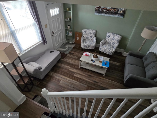 living room featuring dark hardwood / wood-style floors and plenty of natural light