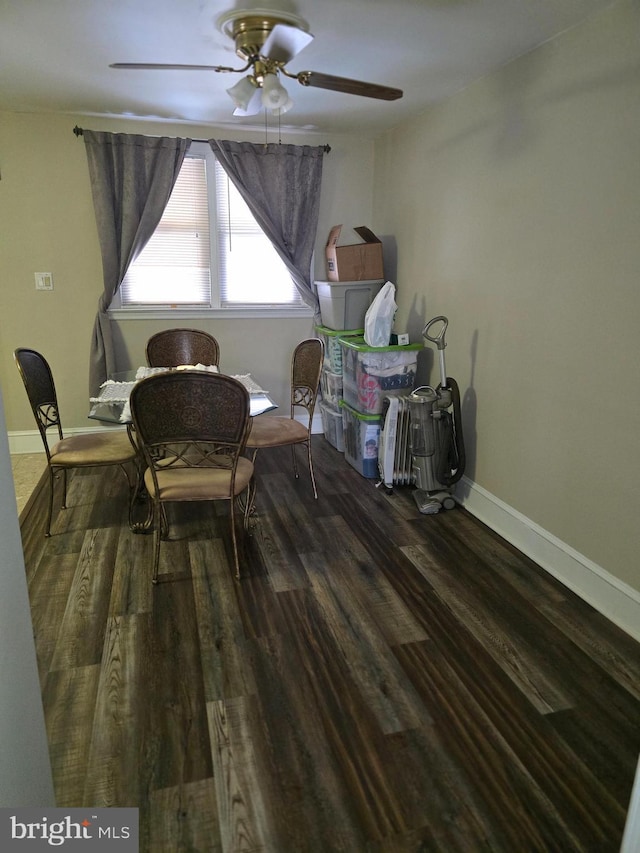 dining space with ceiling fan and dark hardwood / wood-style flooring