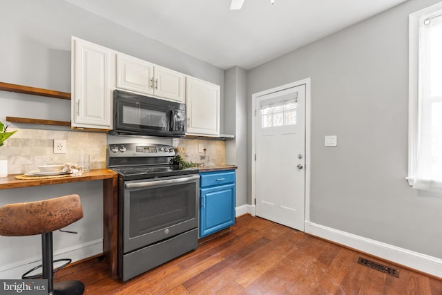 kitchen with white cabinetry, decorative backsplash, dark hardwood / wood-style floors, stainless steel electric range, and blue cabinets