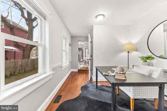 home office featuring plenty of natural light and hardwood / wood-style floors