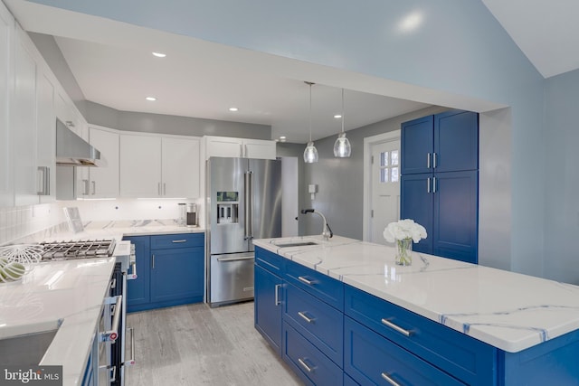 kitchen with high end fridge, blue cabinets, ventilation hood, light wood-style floors, and a sink