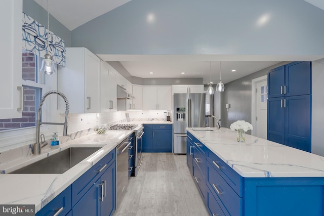 kitchen featuring under cabinet range hood, a spacious island, a sink, blue cabinetry, and appliances with stainless steel finishes