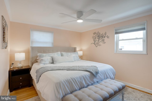 bedroom featuring ornamental molding, ceiling fan, and wood finished floors