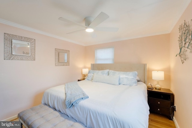 bedroom featuring a ceiling fan, baseboards, ornamental molding, and wood finished floors