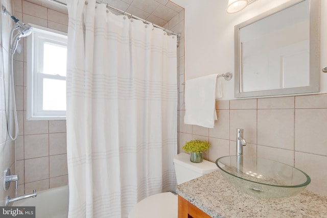 bathroom with toilet, shower / tub combo, vanity, tile walls, and decorative backsplash