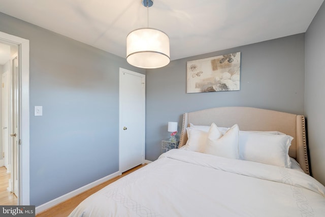 bedroom featuring baseboards and light wood-style floors