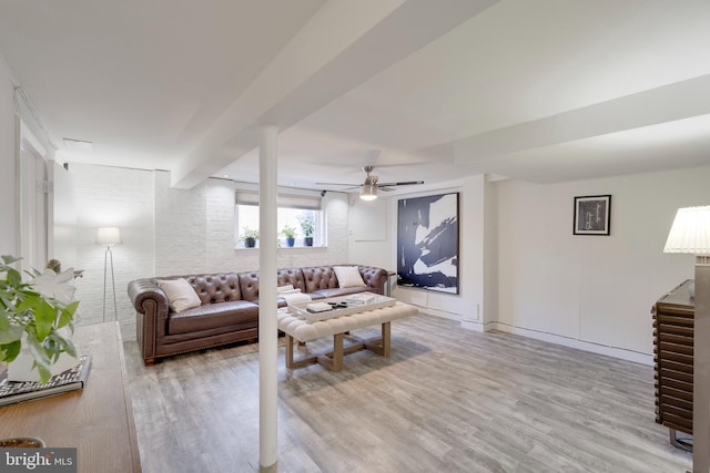 living area featuring light wood-style flooring and a ceiling fan