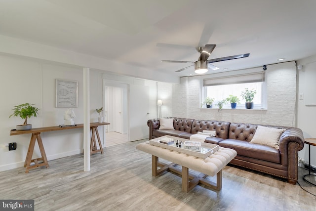 living area with ceiling fan and light wood-style flooring