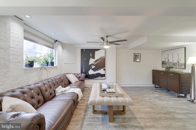 living area with ceiling fan, brick wall, wood finished floors, and recessed lighting