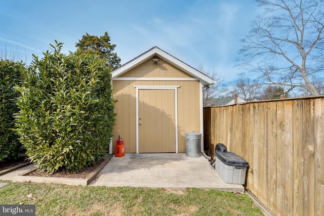 view of shed featuring fence