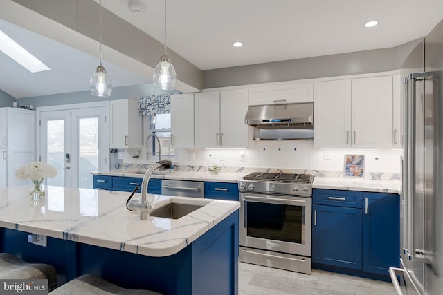 kitchen featuring backsplash, appliances with stainless steel finishes, white cabinetry, blue cabinets, and under cabinet range hood