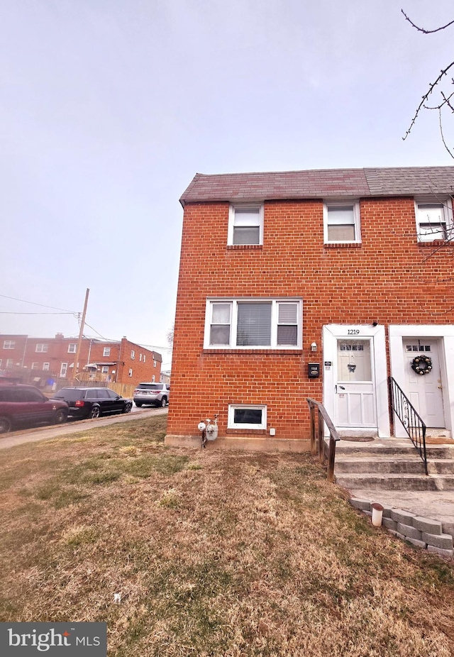 rear view of property with a yard