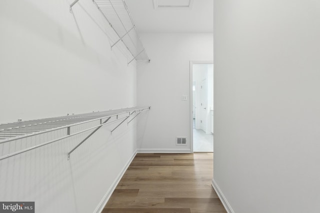 walk in closet featuring hardwood / wood-style floors