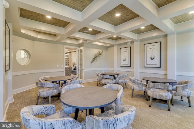 dining space with light colored carpet, beamed ceiling, and coffered ceiling