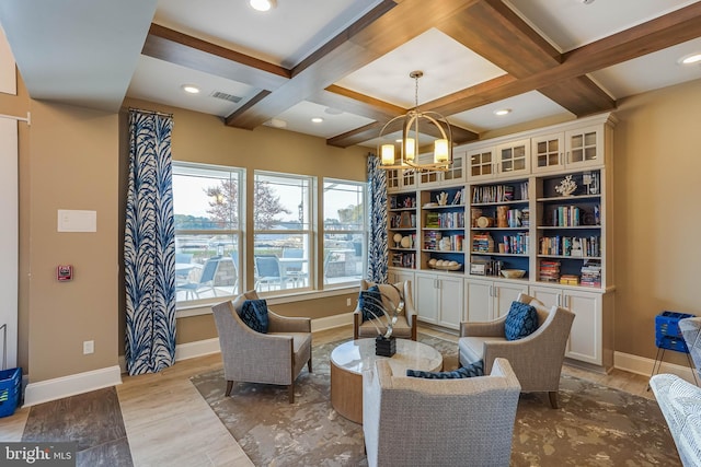 living area featuring an inviting chandelier, light hardwood / wood-style floors, coffered ceiling, and beamed ceiling