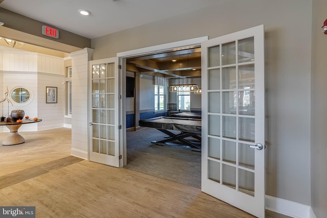 hallway featuring hardwood / wood-style floors and french doors