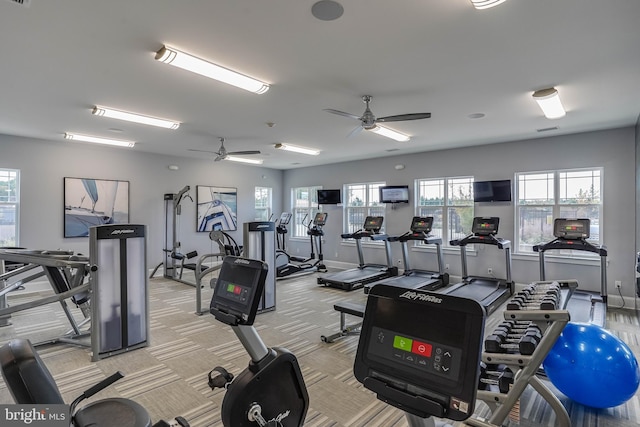 gym with ceiling fan and light colored carpet