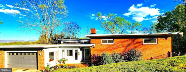 view of front facade with a mountain view and a garage