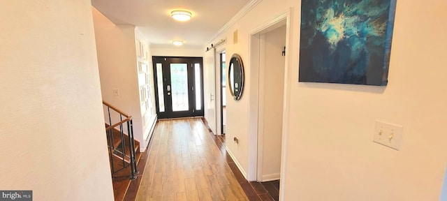 hallway featuring dark wood-type flooring and crown molding