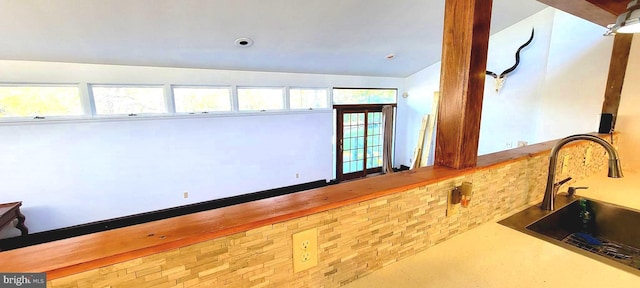 interior space with sink and vaulted ceiling