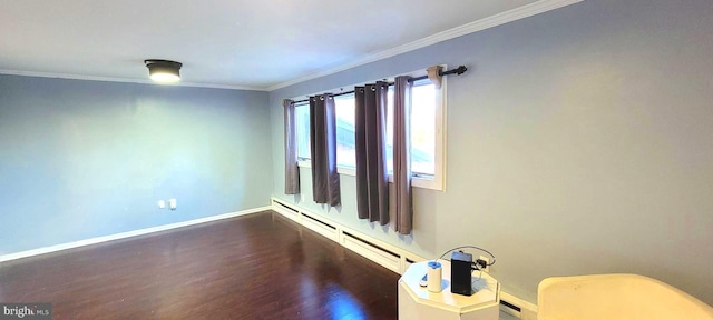 spare room with a baseboard heating unit, dark hardwood / wood-style flooring, and ornamental molding