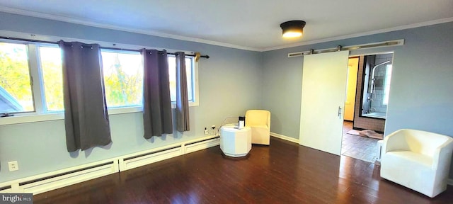 sitting room featuring a baseboard heating unit, dark hardwood / wood-style floors, ornamental molding, and a barn door