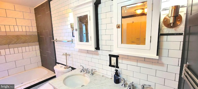 bathroom featuring backsplash, a bath, tile walls, and vanity