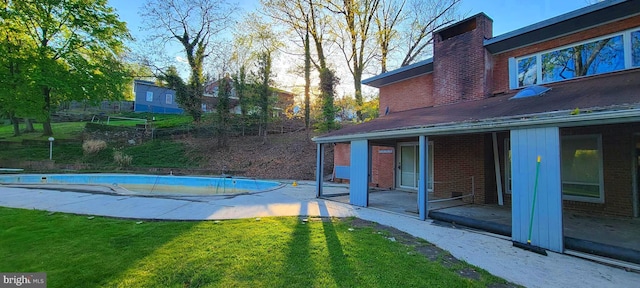 view of swimming pool with a lawn and a patio