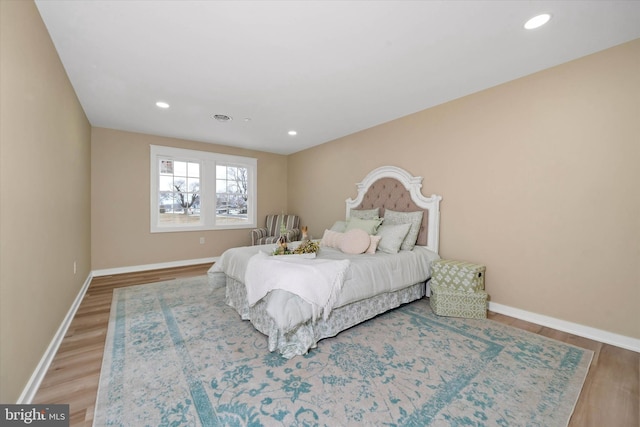 bedroom with hardwood / wood-style flooring