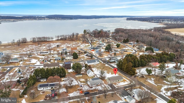 snowy aerial view featuring a water view