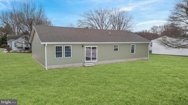 rear view of house featuring a lawn